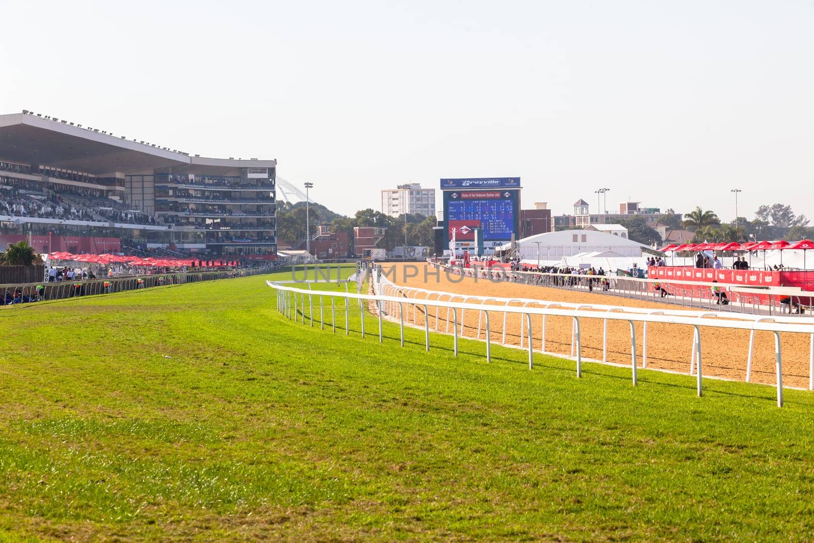 Horse racing action of jockeys races at Greyville racecouse sand and grass for Durban July vodacom cup.