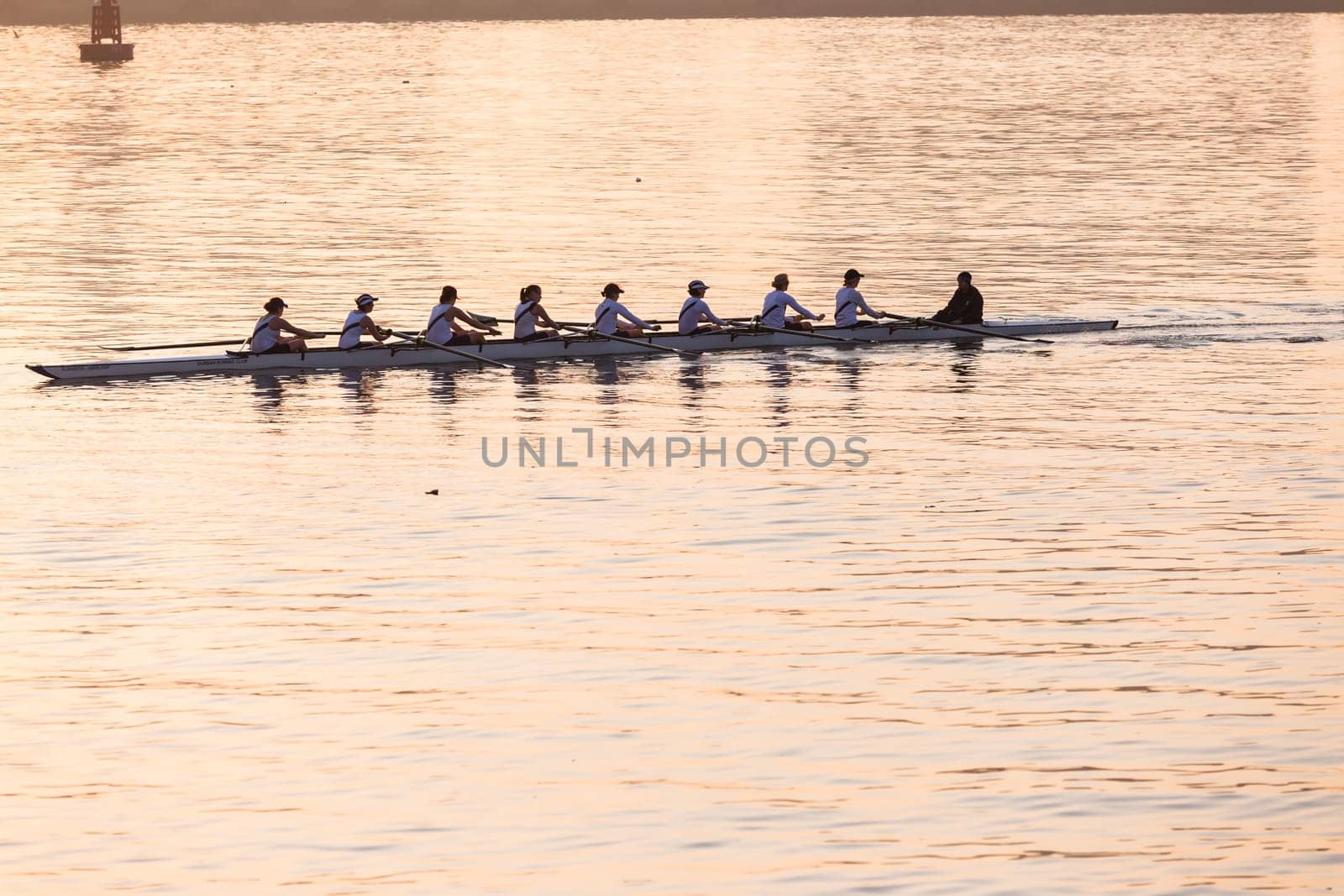 Regatta rowing crews eights quads doubles skulls on race course silhouetted on morning sunrise colors on sea waters at Durban Rowiing Club Head of the Bay Regatta July 12th 2014 Durban South-Africa