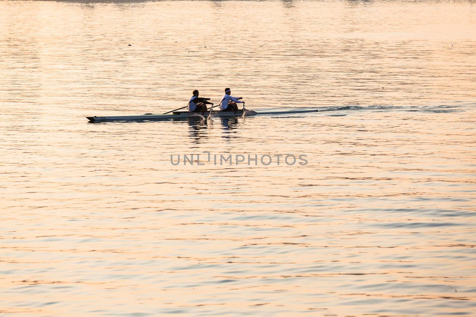 Regatta rowing crews eights quads doubles skulls on race course silhouetted on morning sunrise colors on sea waters at Durban Rowiing Club Head of the Bay Regatta July 12th 2014 Durban South-Africa