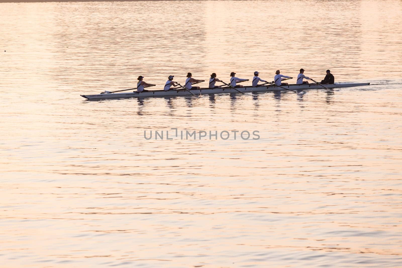 Regatta rowing crews eights quads doubles skulls on race course silhouetted on morning sunrise colors on sea waters at Durban Rowiing Club Head of the Bay Regatta July 12th 2014 Durban South-Africa