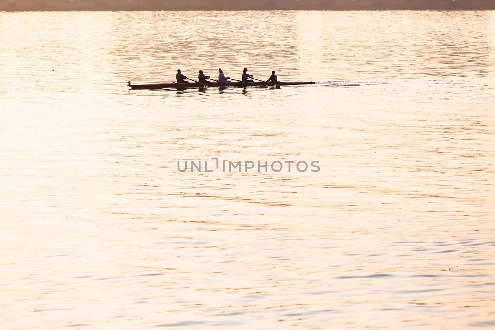 Regatta rowing crews eights quads doubles skulls on race course silhouetted on morning sunrise colors on sea waters at Durban Rowiing Club Head of the Bay Regatta July 12th 2014 Durban South-Africa