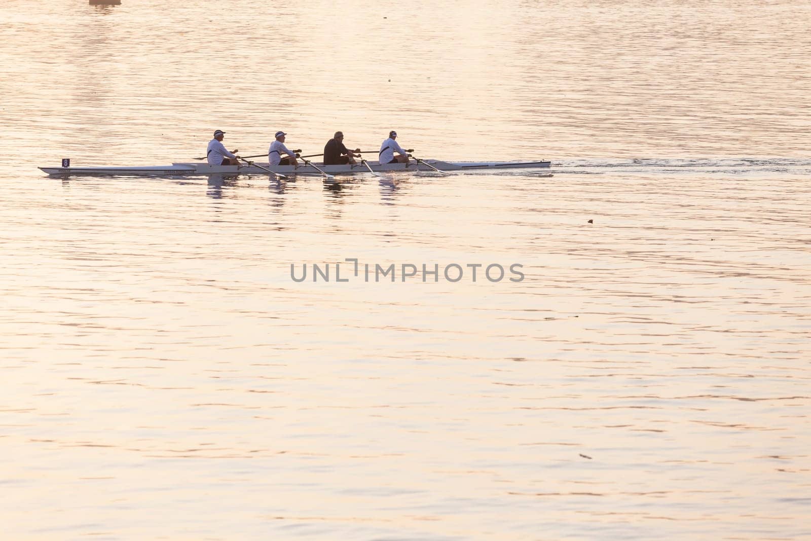 Regatta rowing crews eights quads doubles skulls on race course silhouetted on morning sunrise colors on sea waters at Durban Rowiing Club Head of the Bay Regatta July 12th 2014 Durban South-Africa