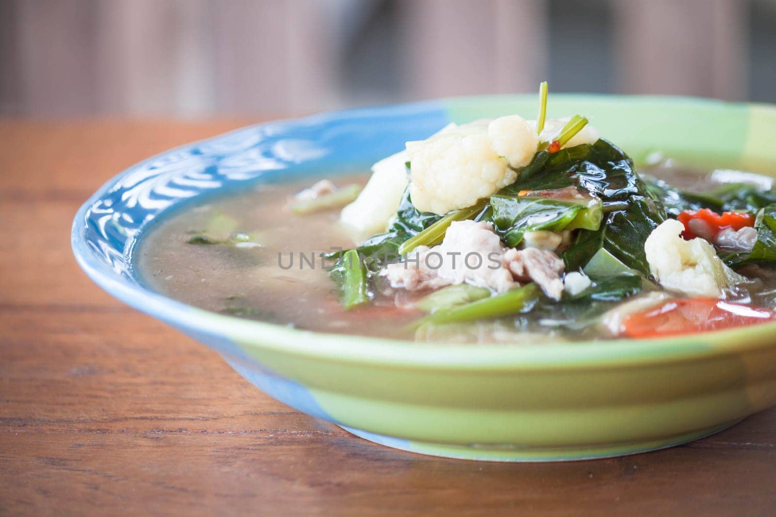 Fried rice noodles topped with pork and vegetable