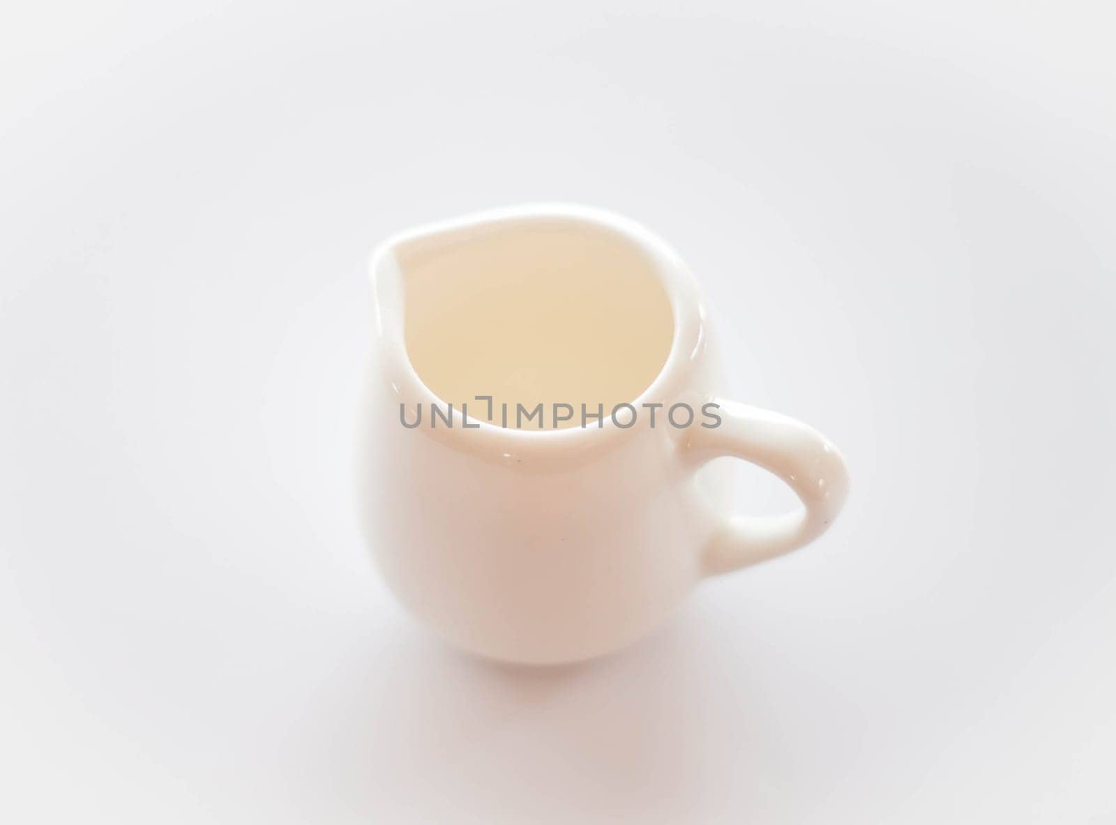 Empty white ceramic pitcher on clean table