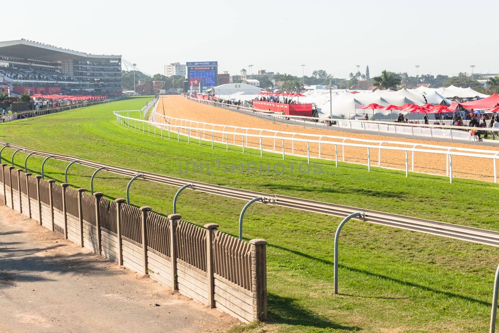 Horse racing action of jockeys races at Greyville racecouse sand and grass for Durban July vodacom cup.