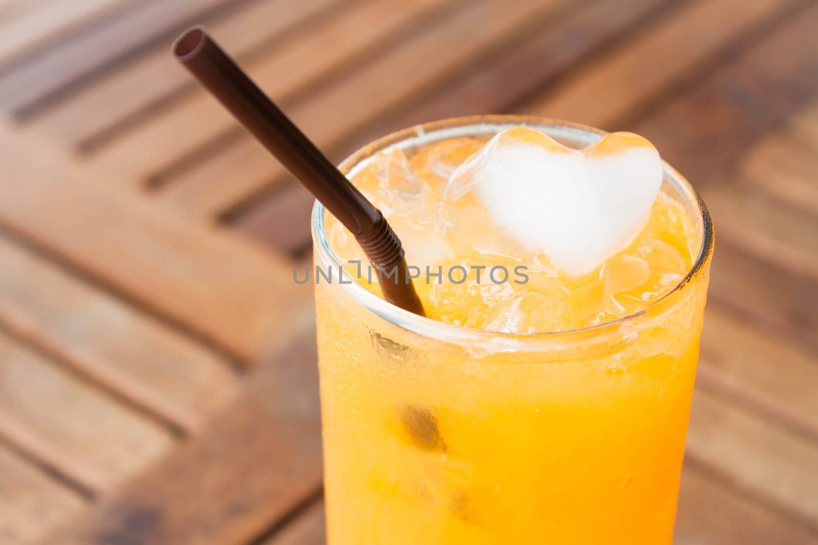 Heart cube ice of fresh orange juice