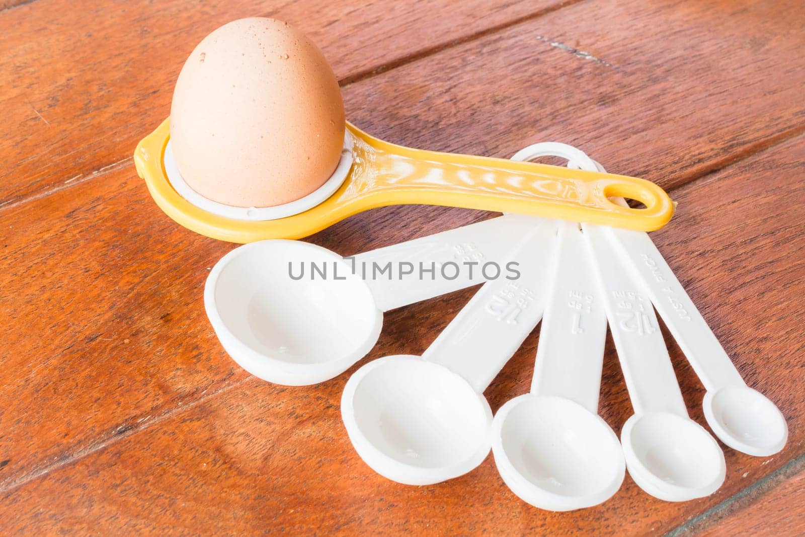 Bakery preparing with egg, yolk separator and spoon