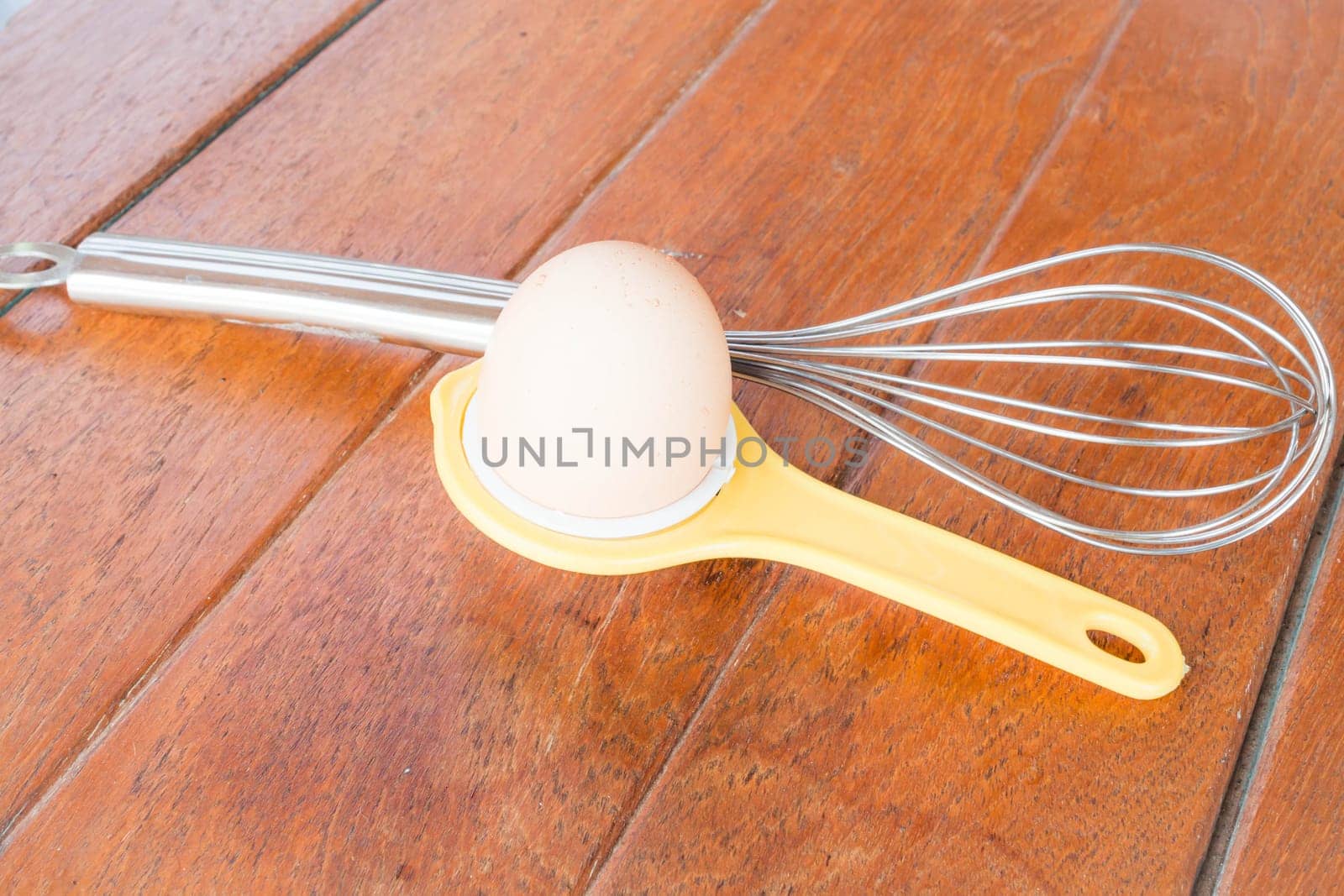 Bakery preparing with egg, yolk separator and hand mixer