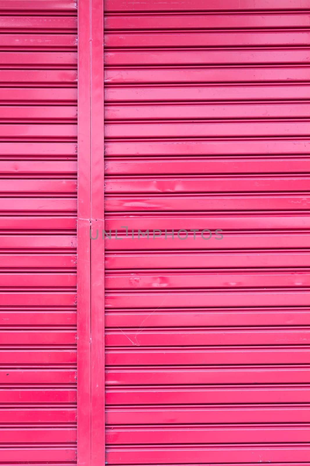 Red roller metal entry door of apartment