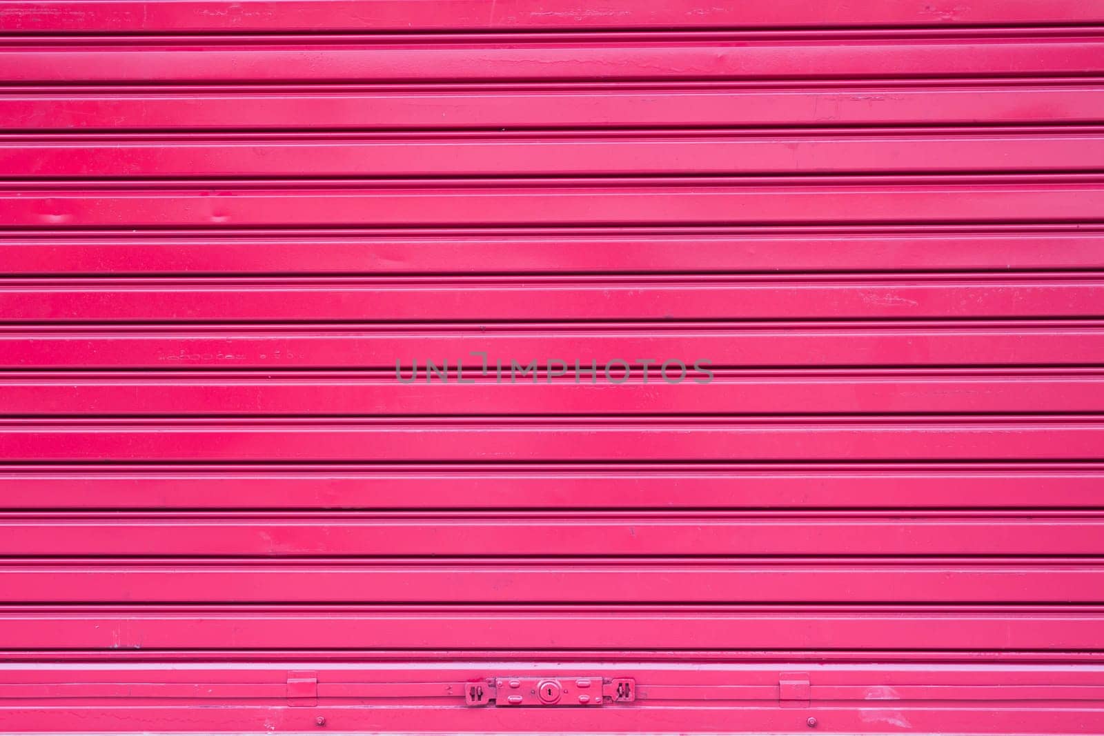 Red roller metal door surface of apartment
