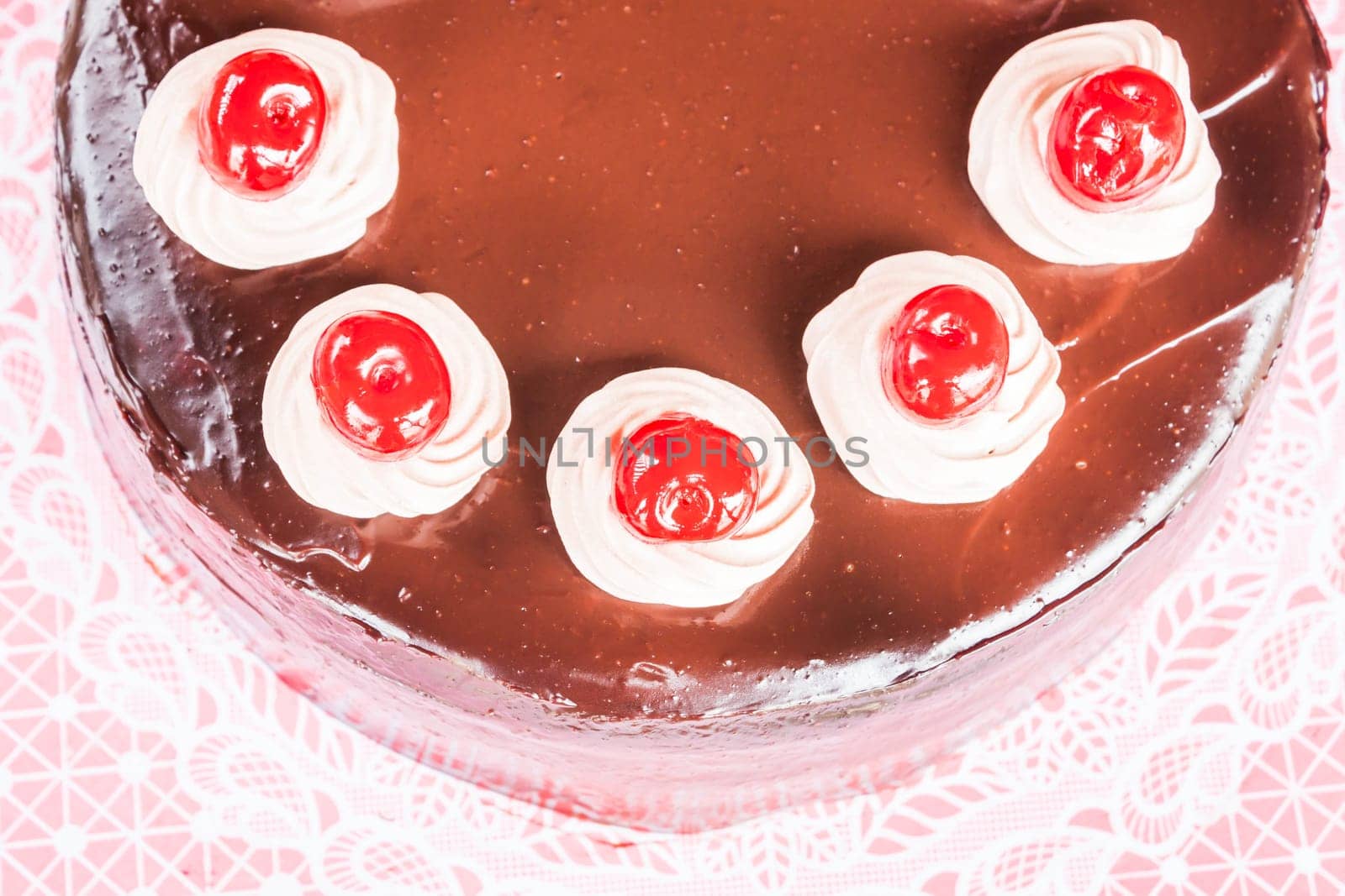 Top view of chocolate cake with red cherry