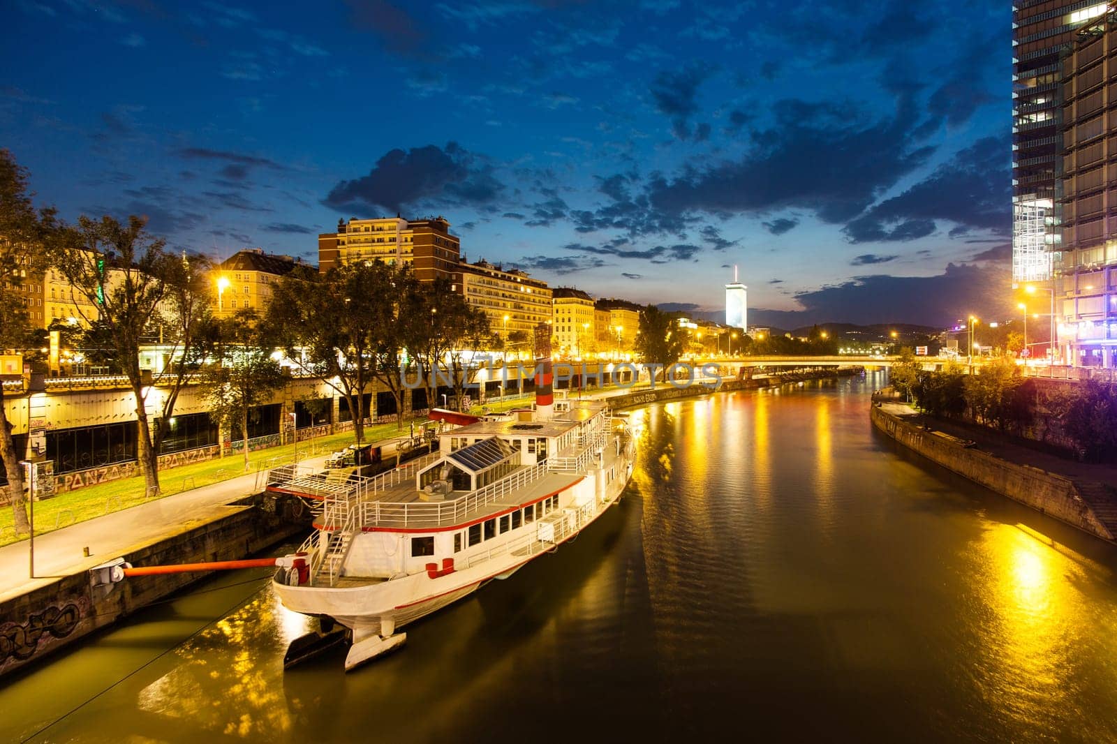 Vienna Danube Canal,cityscape in the evening with a steamship