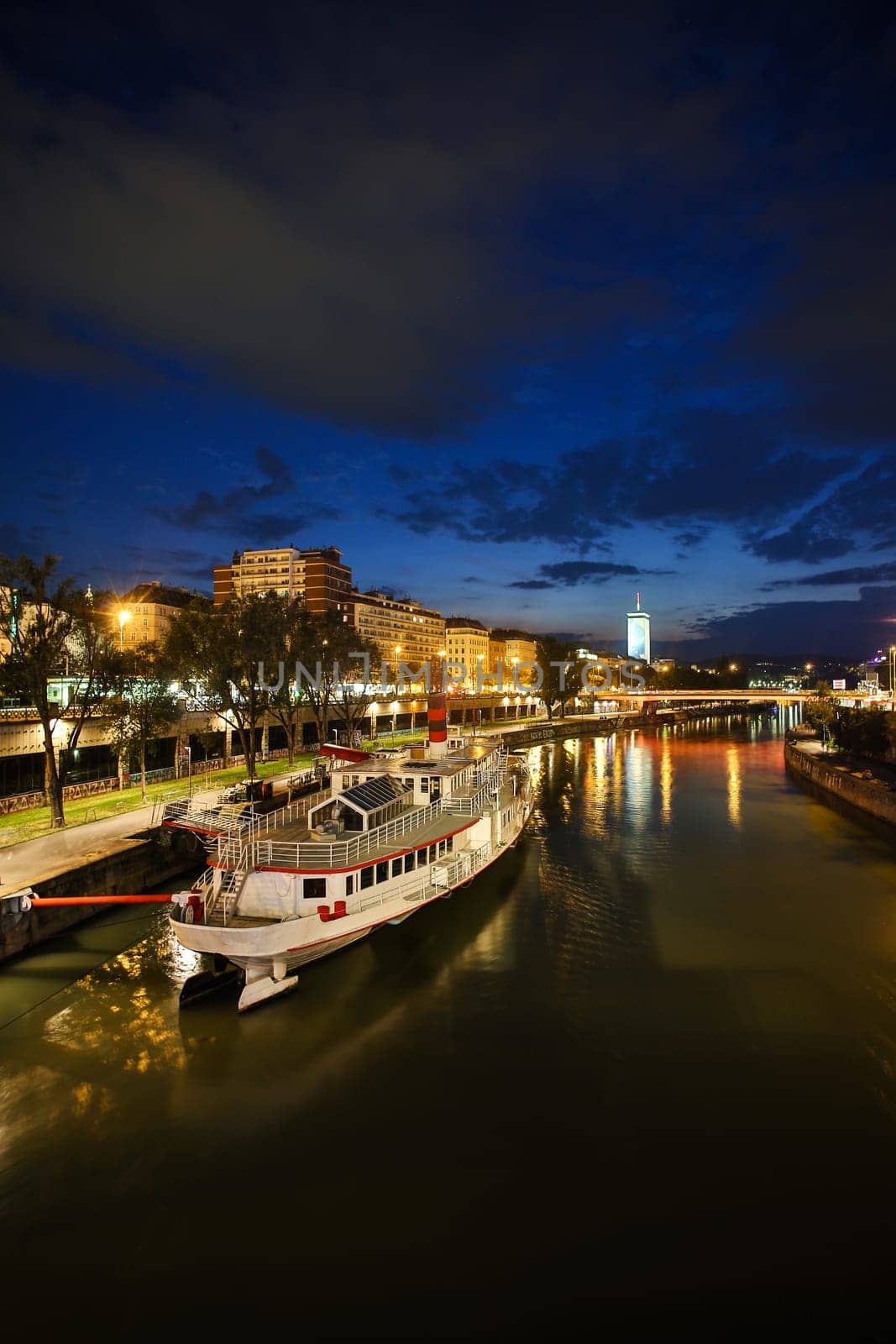 Vienna Danube Canal,cityscape in the evening with a steamship