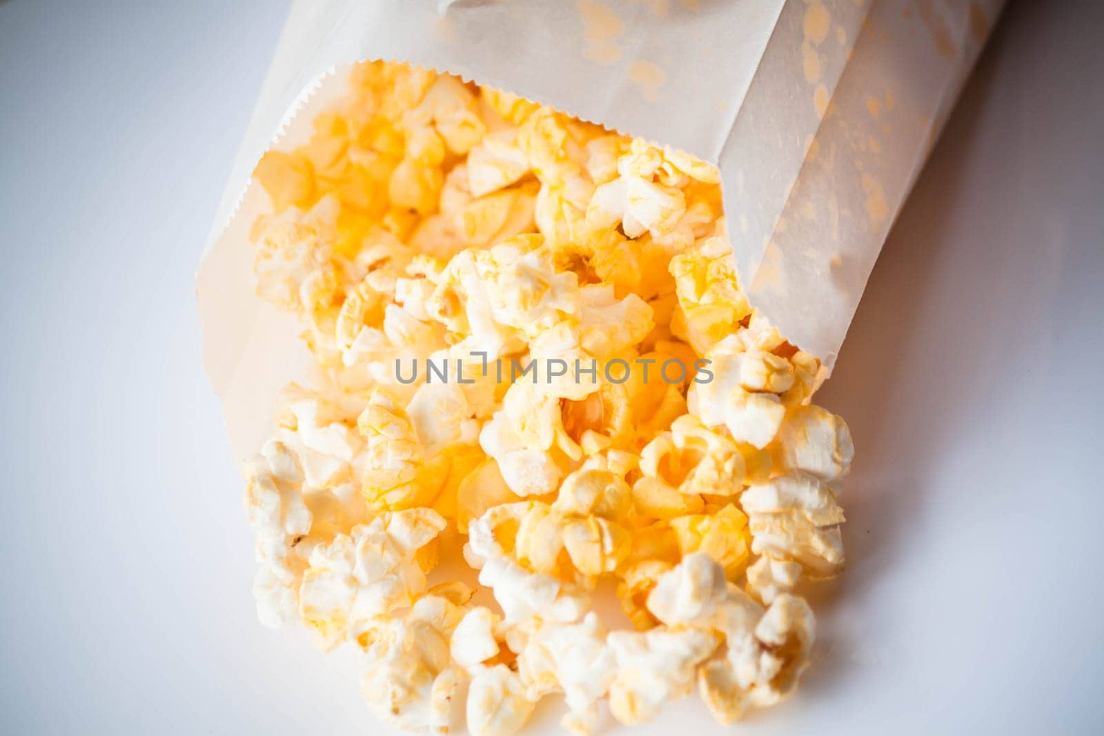Classic popcorn falling out of paper pack