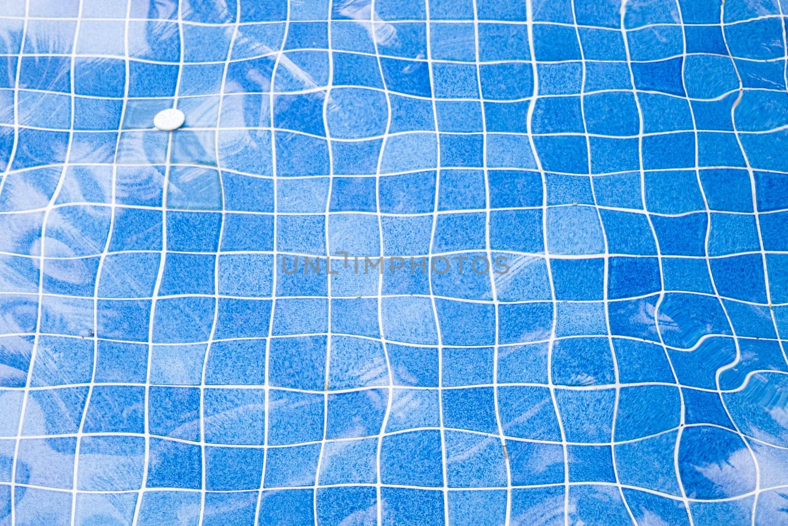 Blue ripped water with blue mosaic in swimming pool