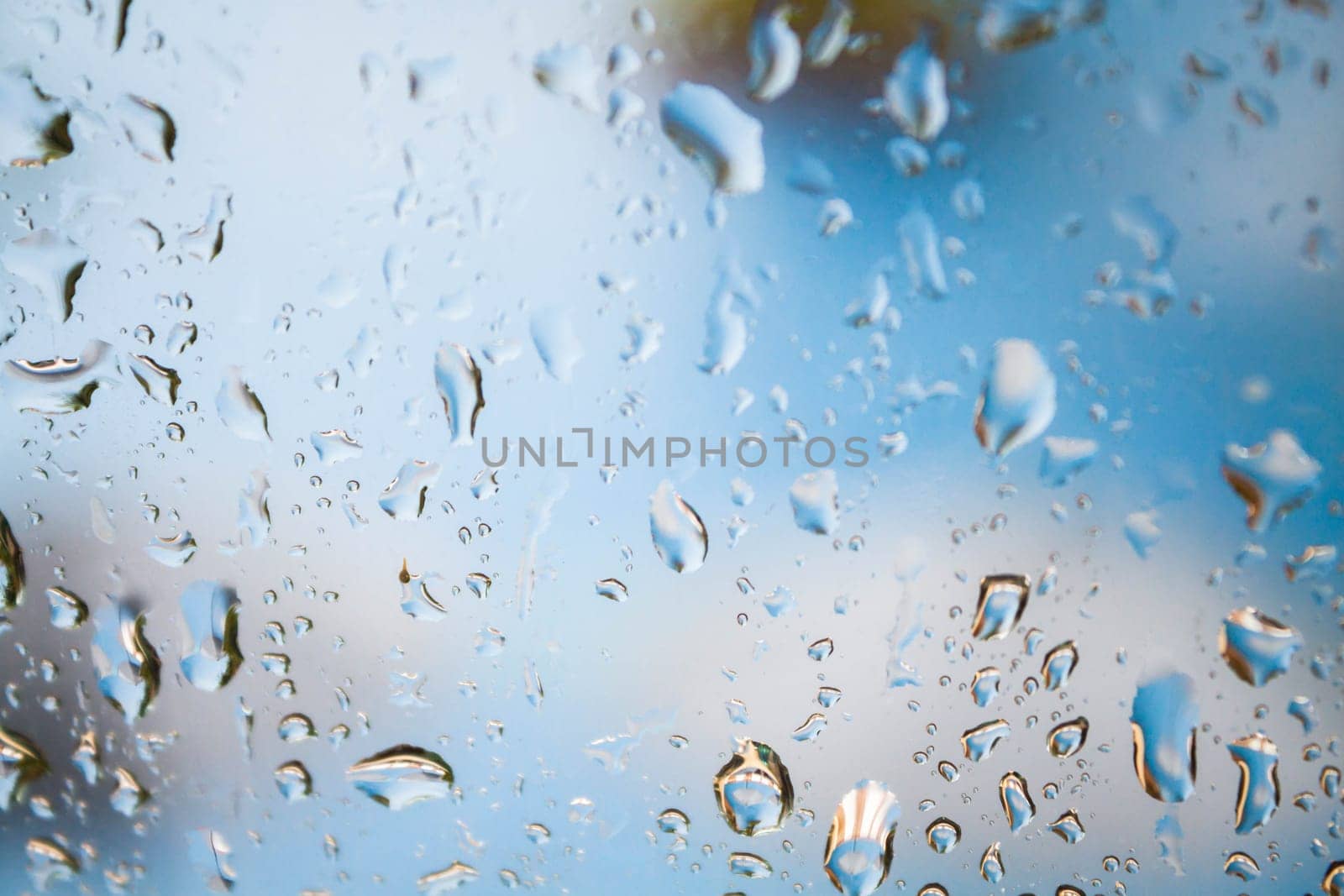 Behind the mirror of rain drops background