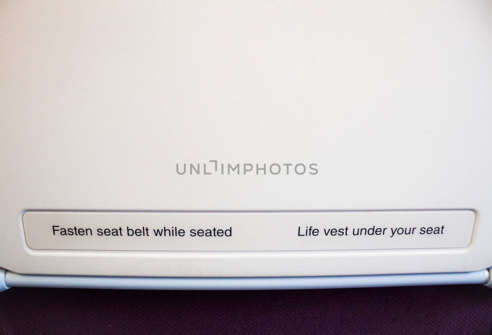 Airplane seat back with caution inform on flight
