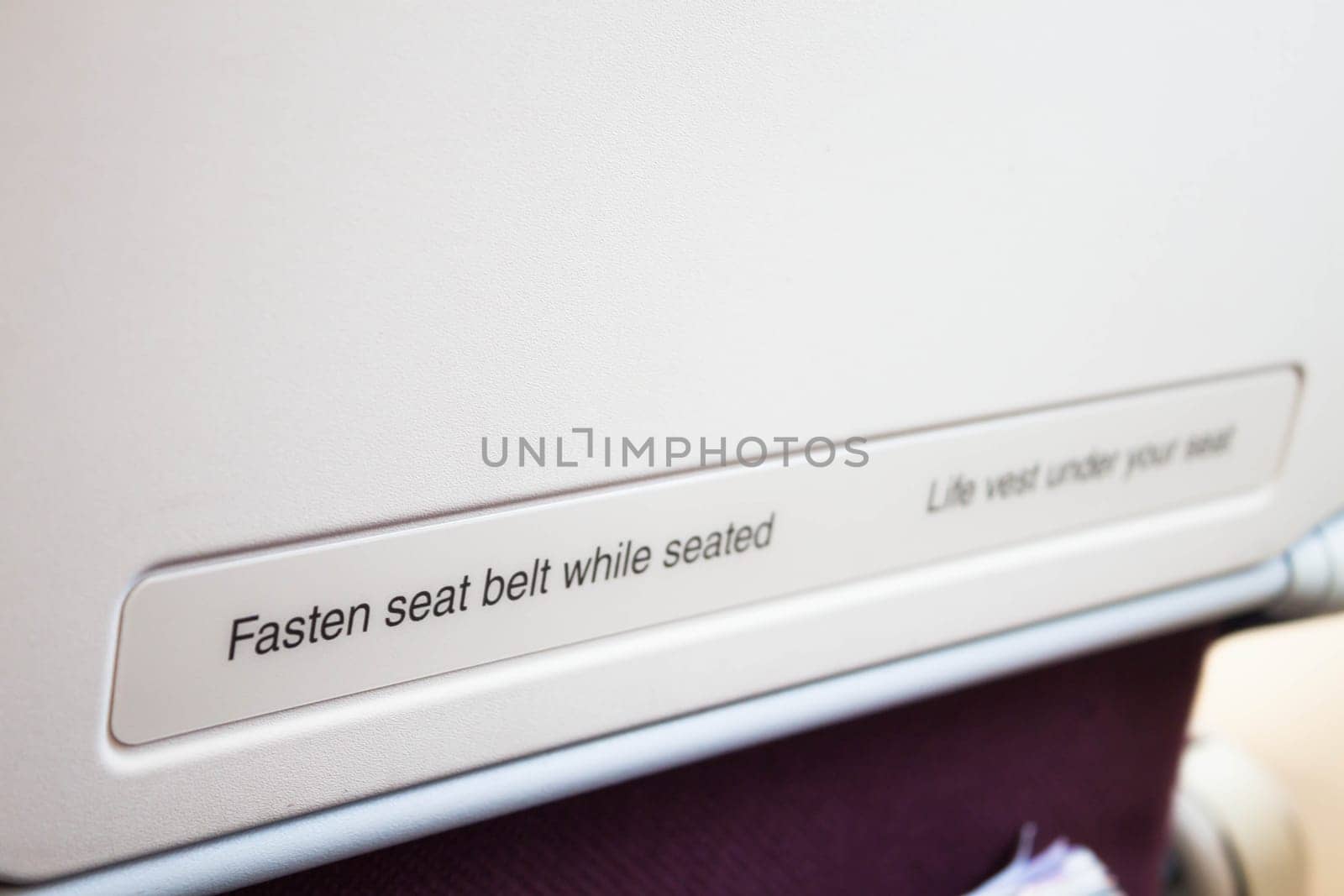 Airplane seat back with caution inform on the flight