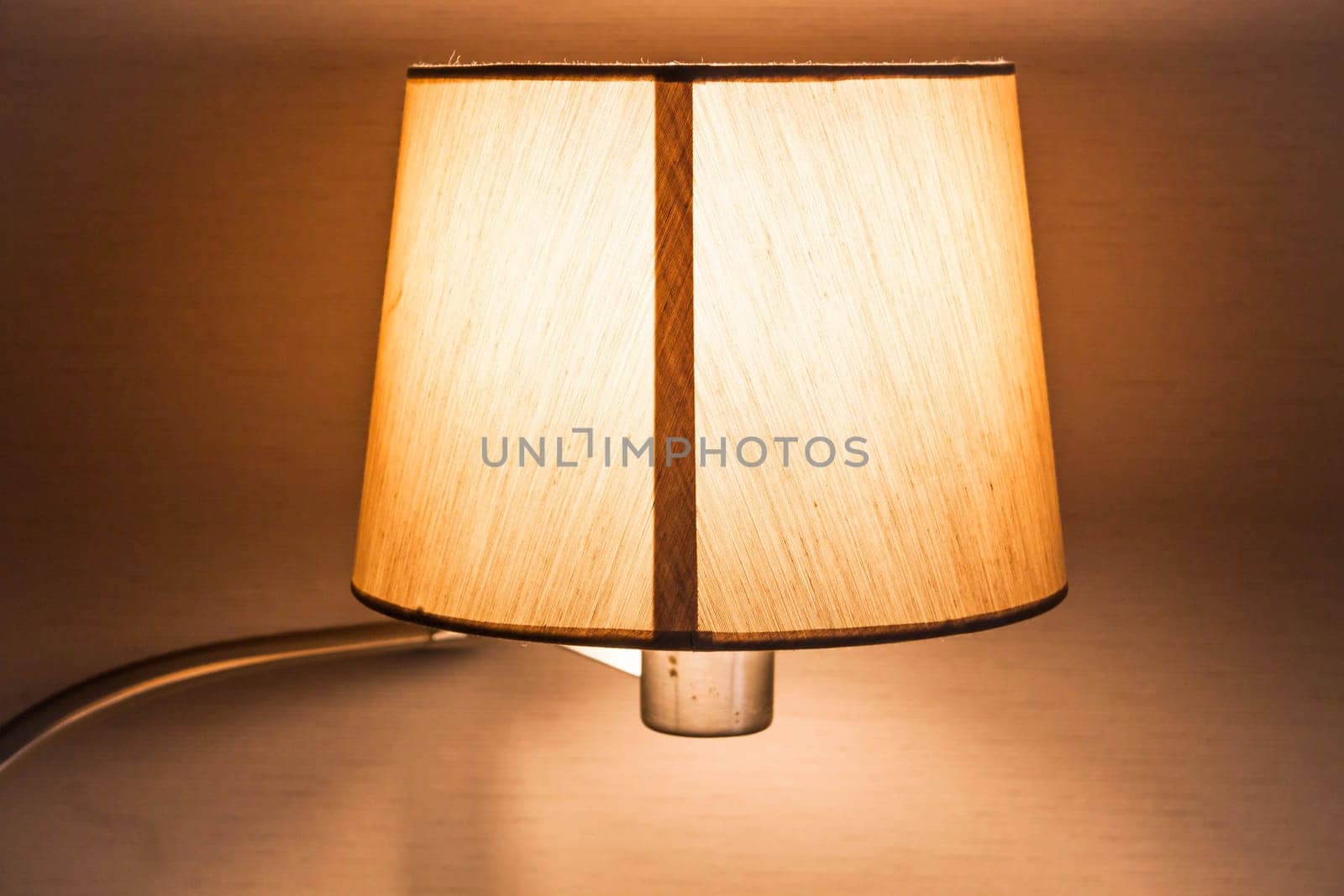 Warm light of work table lamp in room