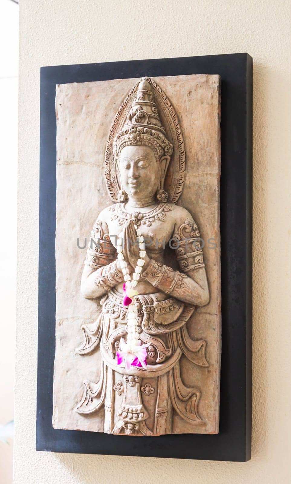 Benign stone sculpture of angel decorated wall
