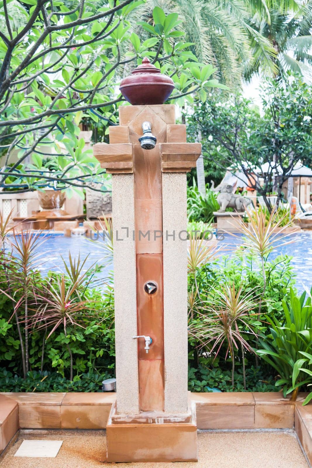 Outdoor shower at swimming pool in resort