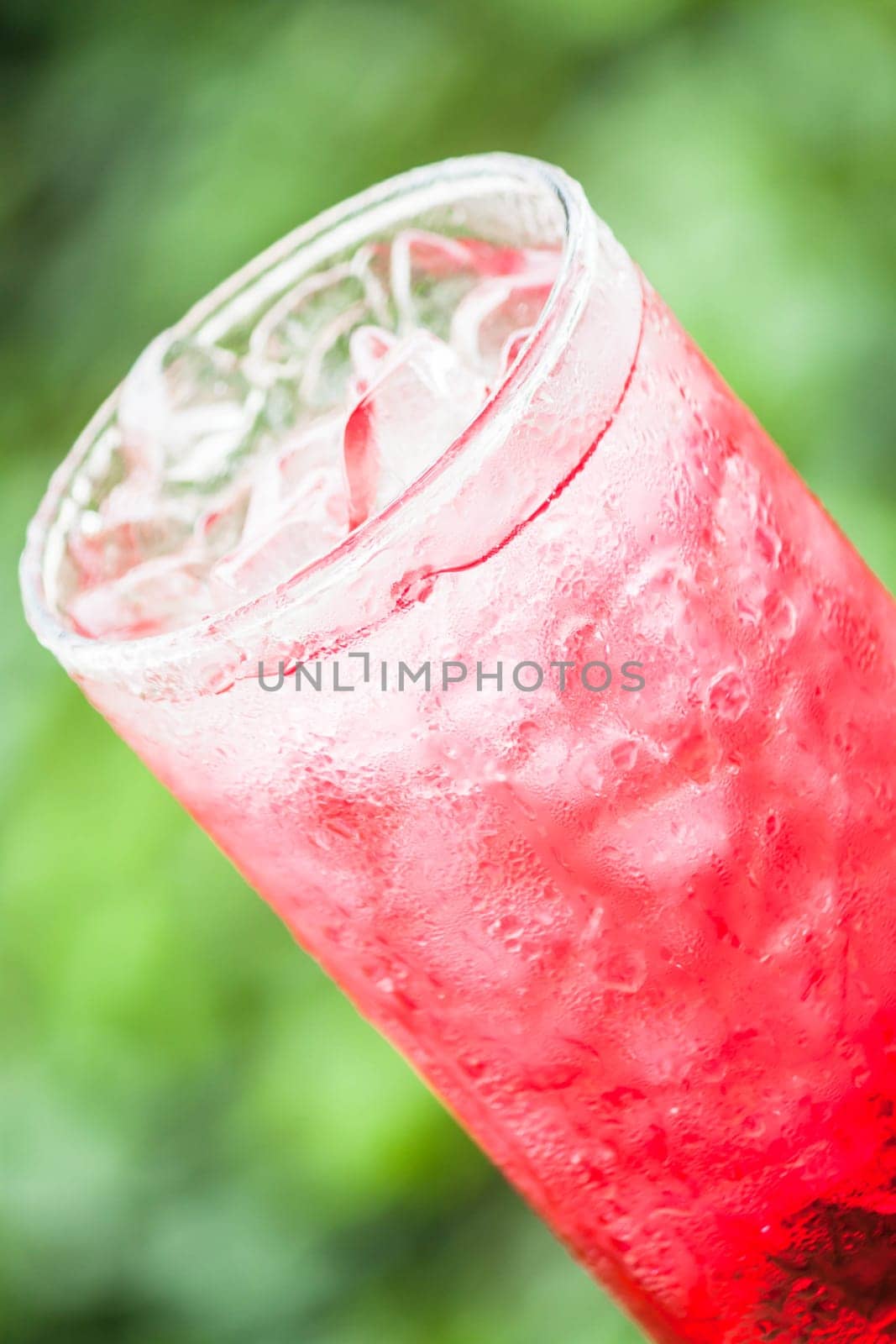 Fresh and cold red drink with ice cubes