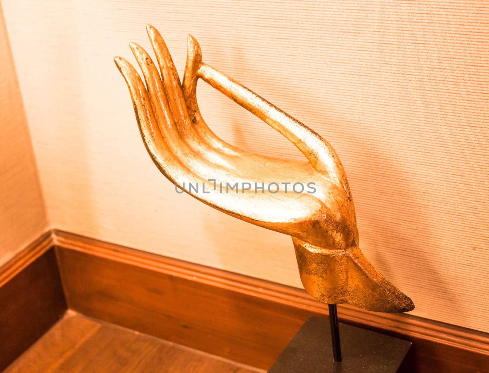 Gold wood carved hand sculpture on wood table