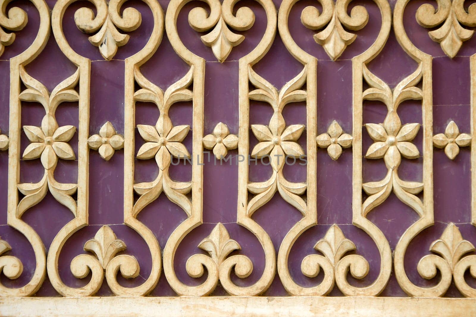 Lovely pattern containing geometrical and floral design on wall at City Palace, Udaipur, Rajasthan, India, Asia