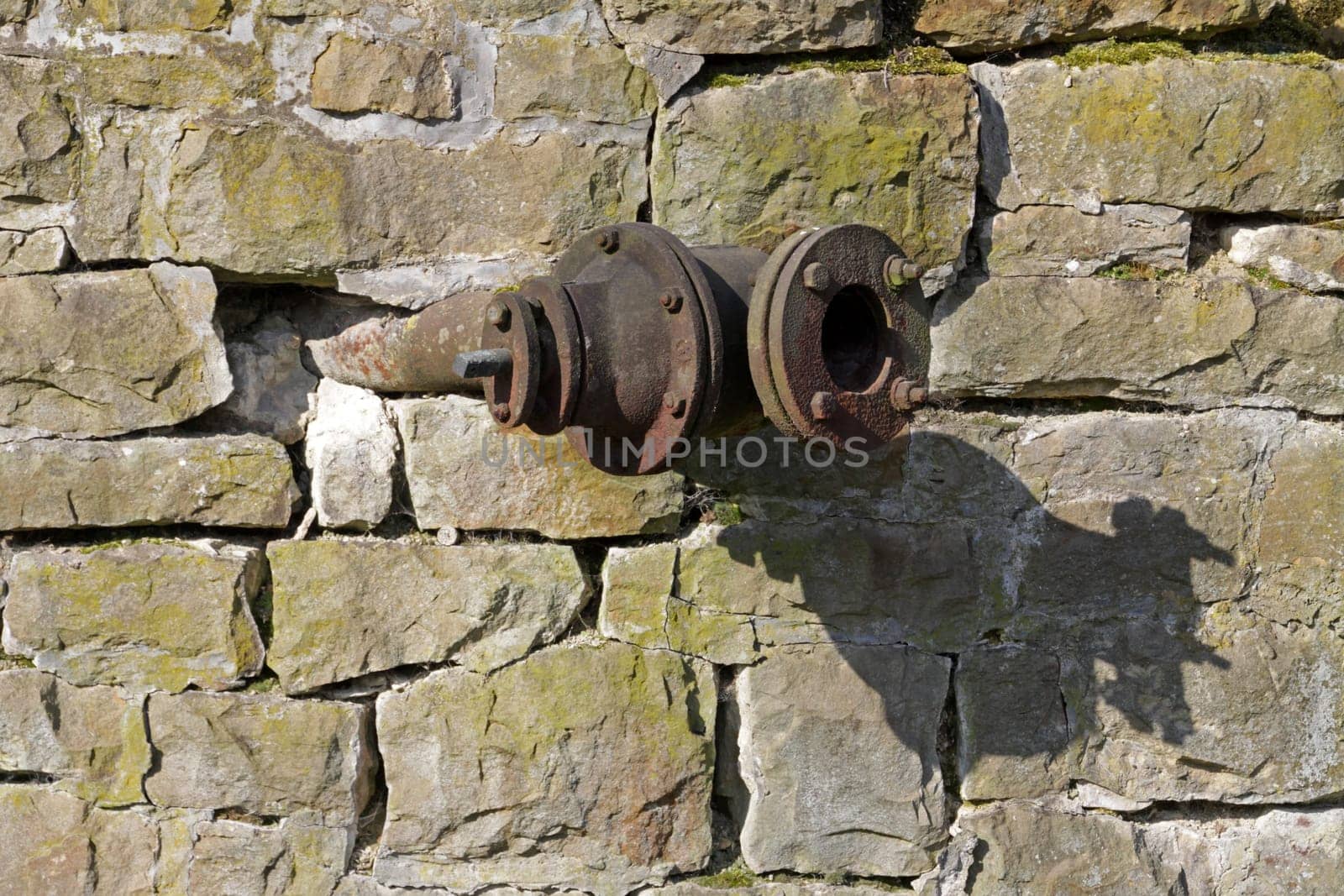 Pipe connections on a quarry stone wall