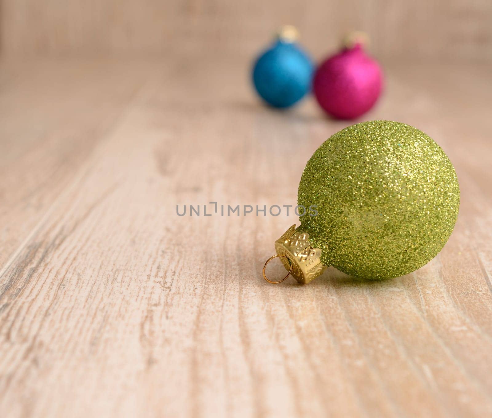 Christmas baubles on a rustic wooden background