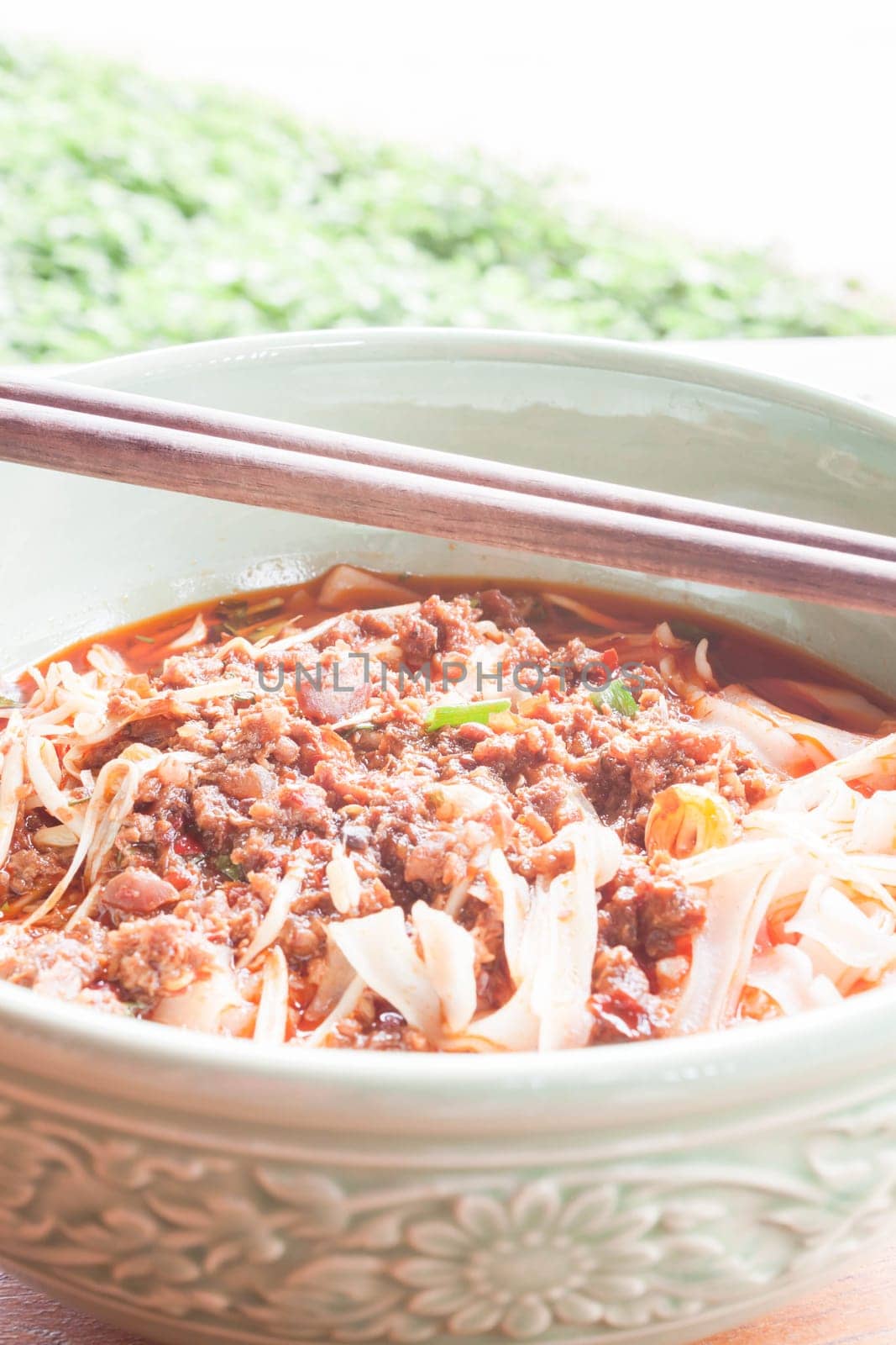 Spicy noodle in meat soup with chopsticks