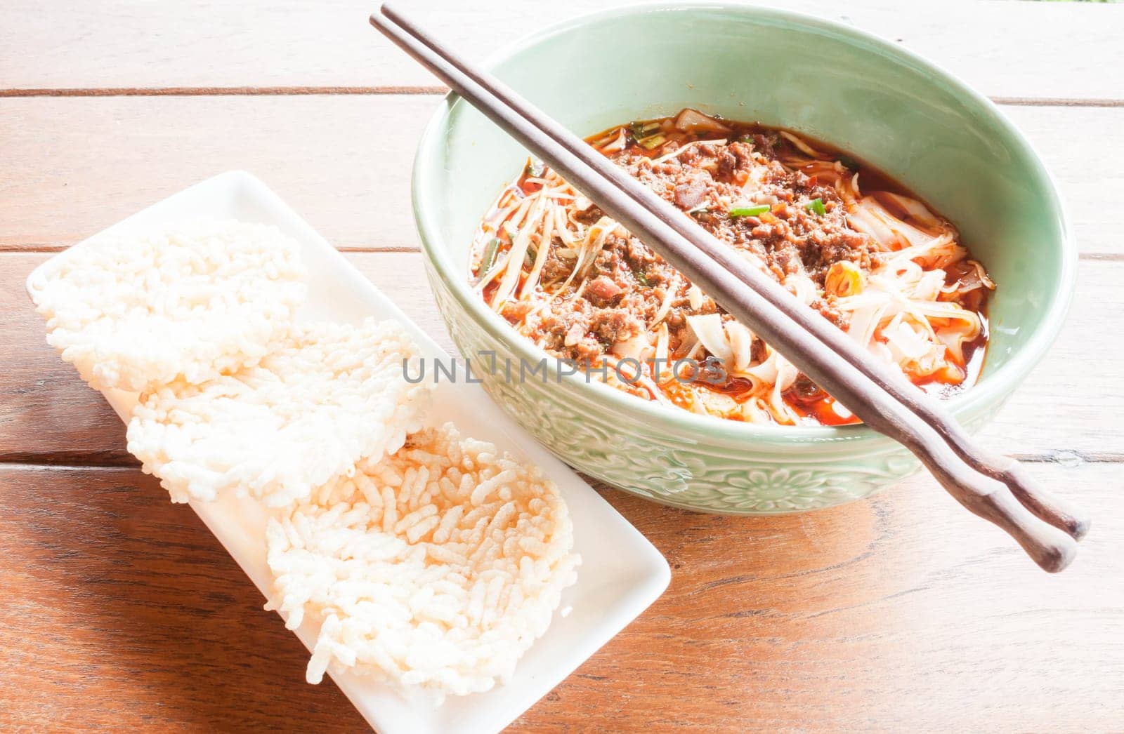 Meal set of spicy noodle soup and crispy rice cracker