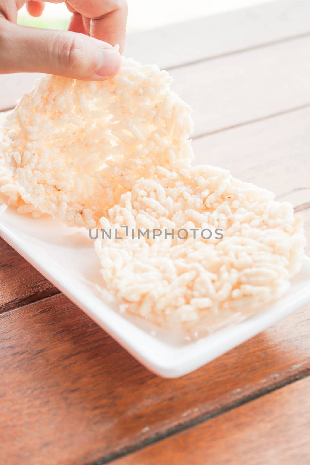 Hand hold thai style crispy rice cracker