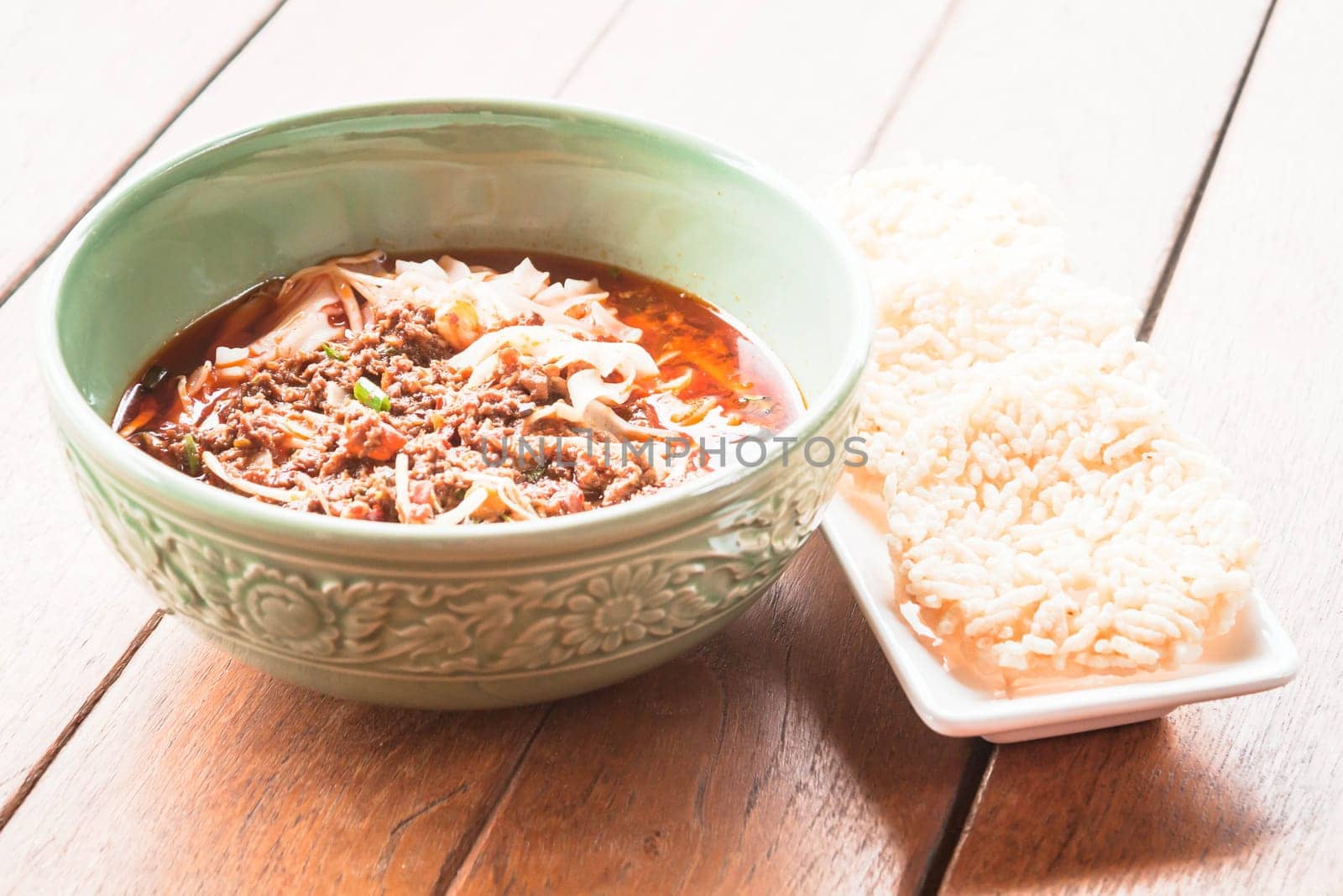 Traditional spicy noodle and crispy rice cracker