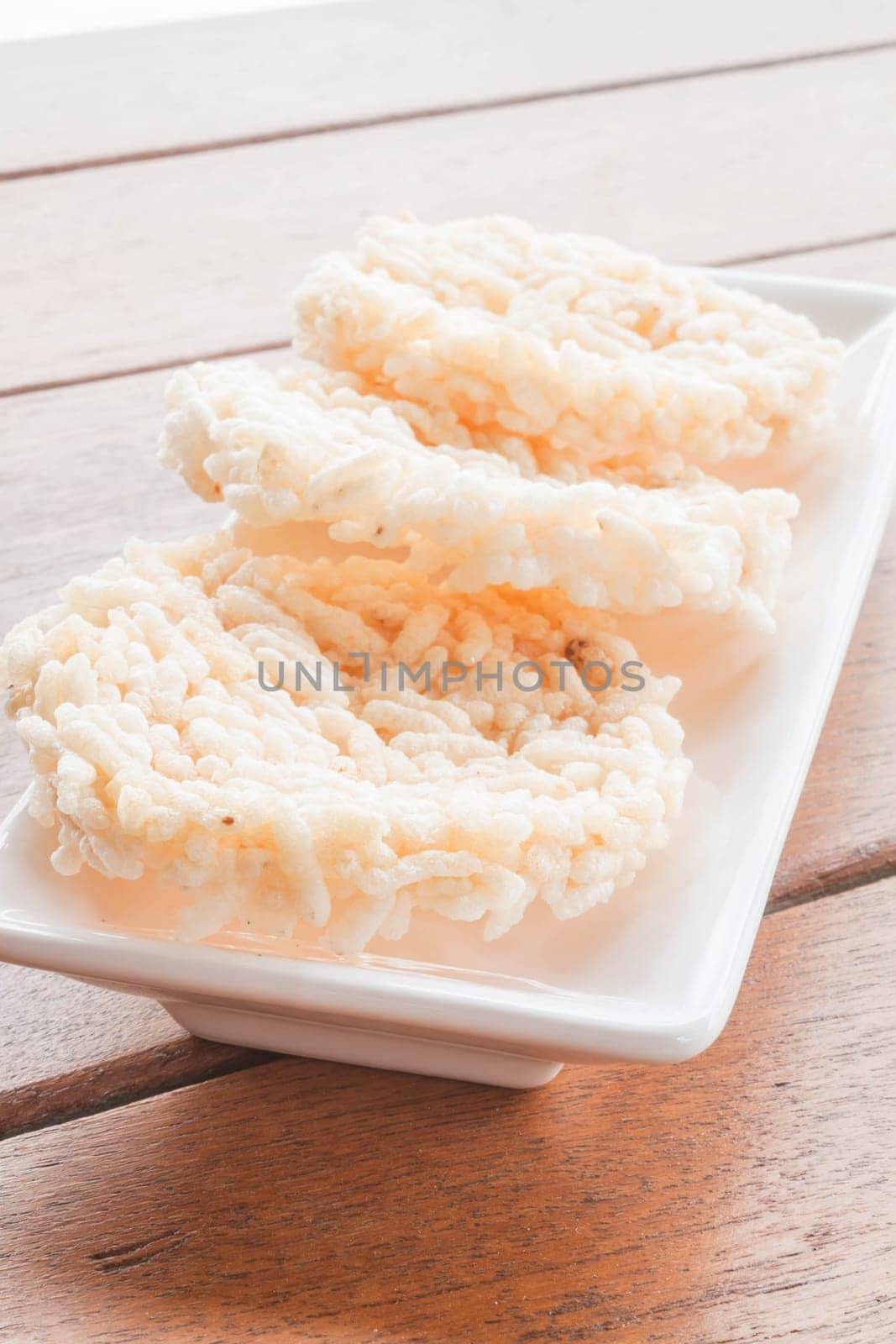 Thai style crispy rice cracker on white plate