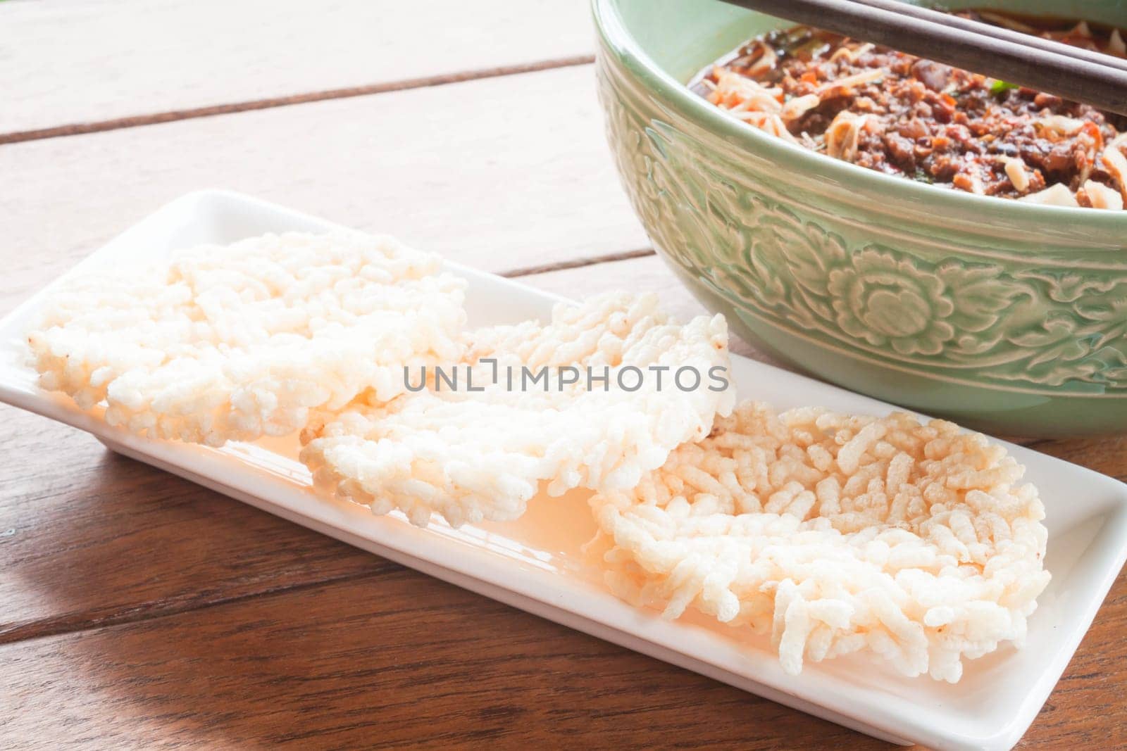 Crispy rice crackers and spicy noodle soup