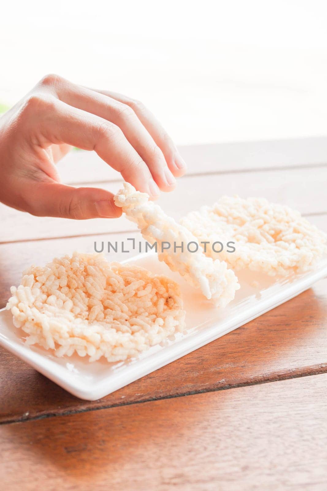 Hand on thai style crispy rice cracker