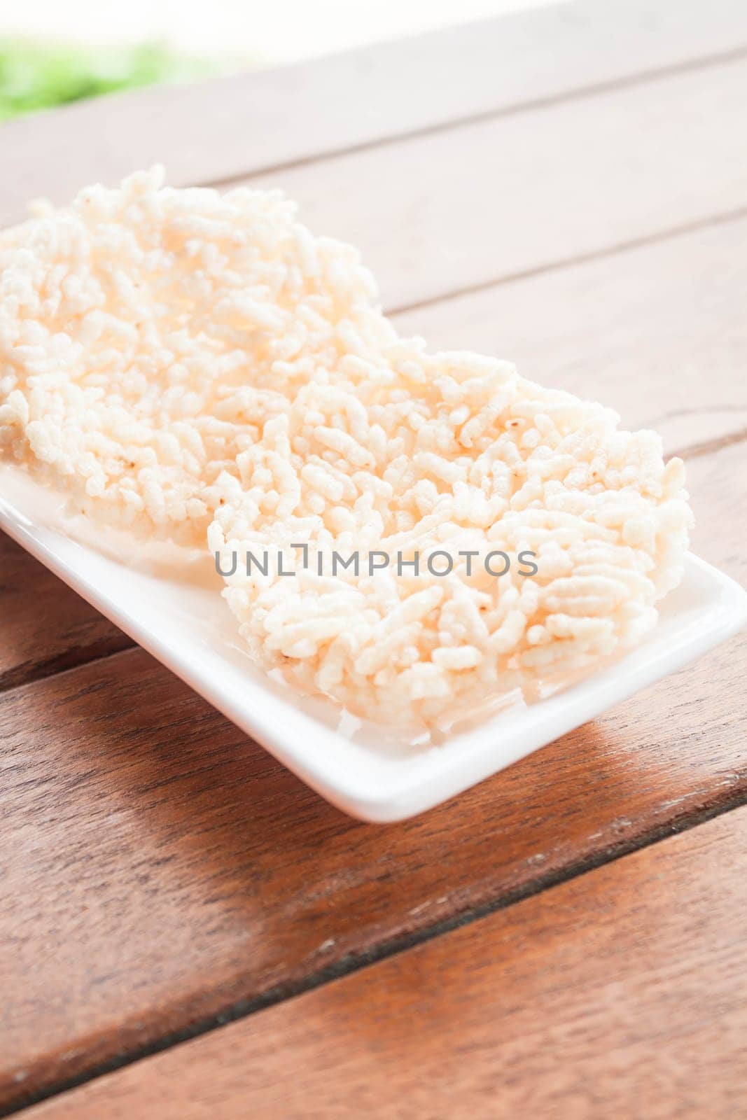 White dish of thai style crispy rice cracker
