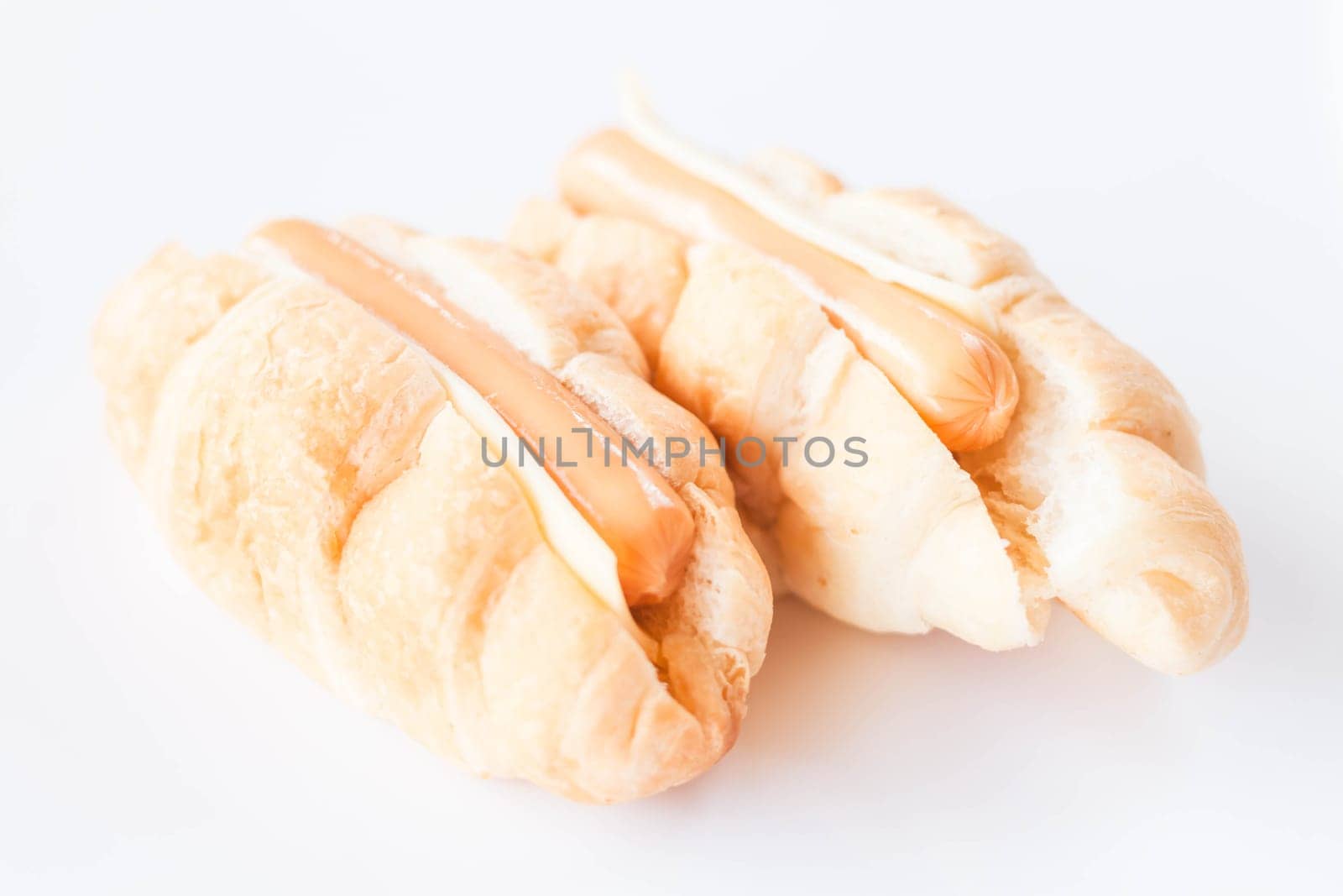 Croissants with sausage and cheese isolated on white background