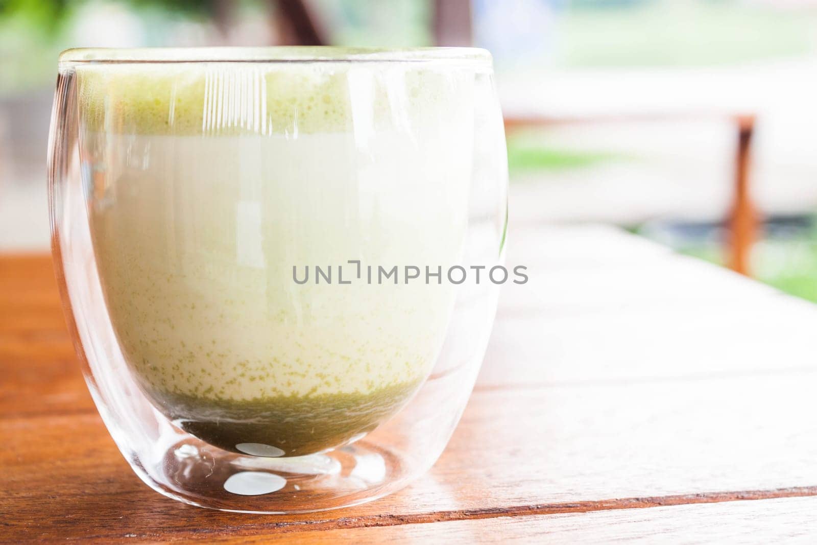 Glass of hot matcha green tea latte at coffee shop