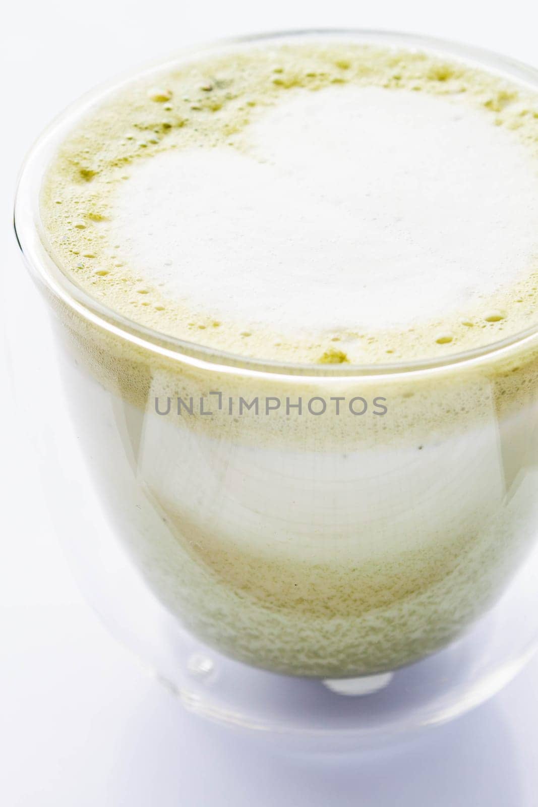 Matcha green tea latte glass isolated on white background