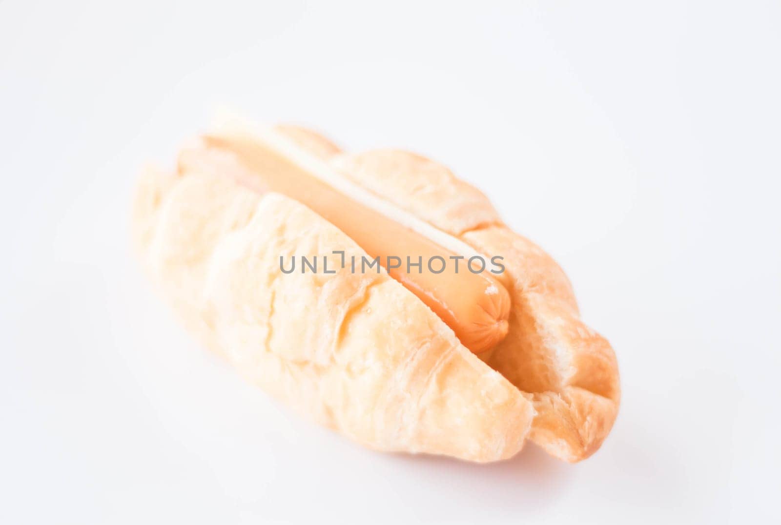 Delicious sausage and cheese croissant on white background