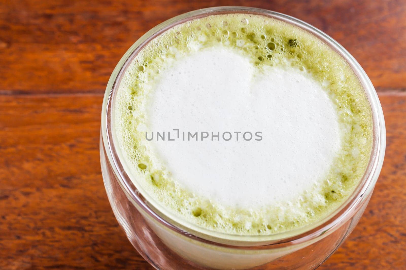 Matcha green tea latte serving on wood table