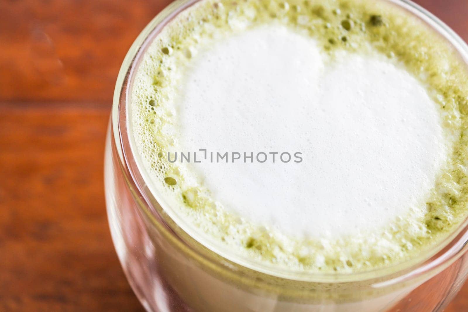 Hot matcha green tea latte in glass