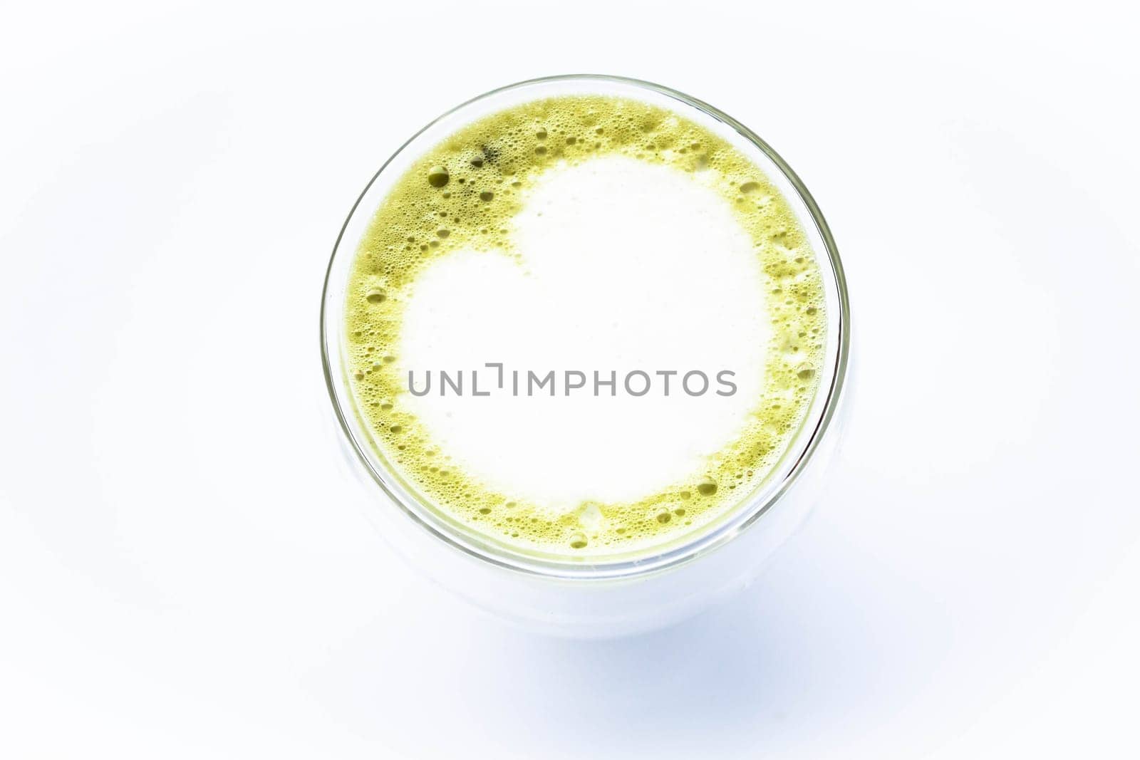 Hot glass of green tea latte isolated on white background