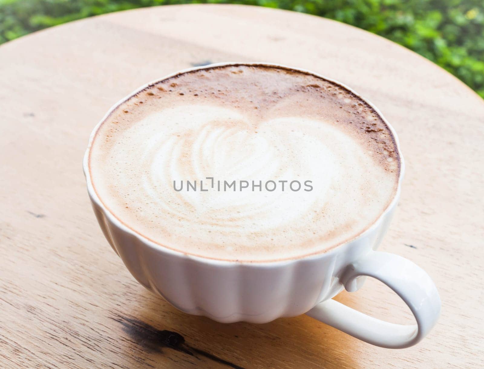 Free pour hot coffee latte cup serving in garden