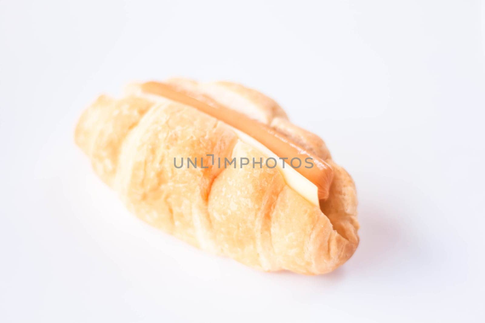 Croissant with sausage and cheese isolated on white background