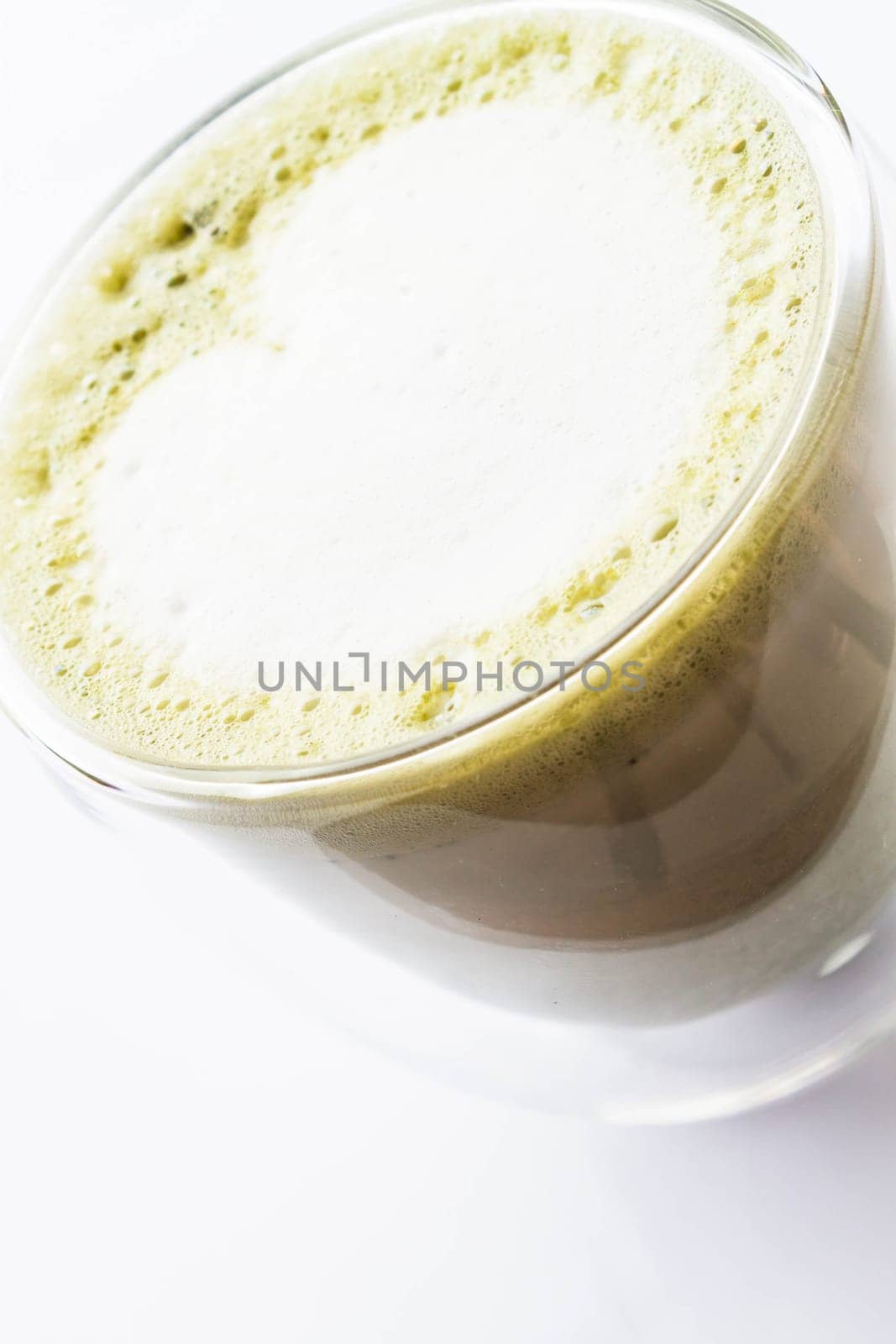 Hot matcha green tea latte isolated on white background