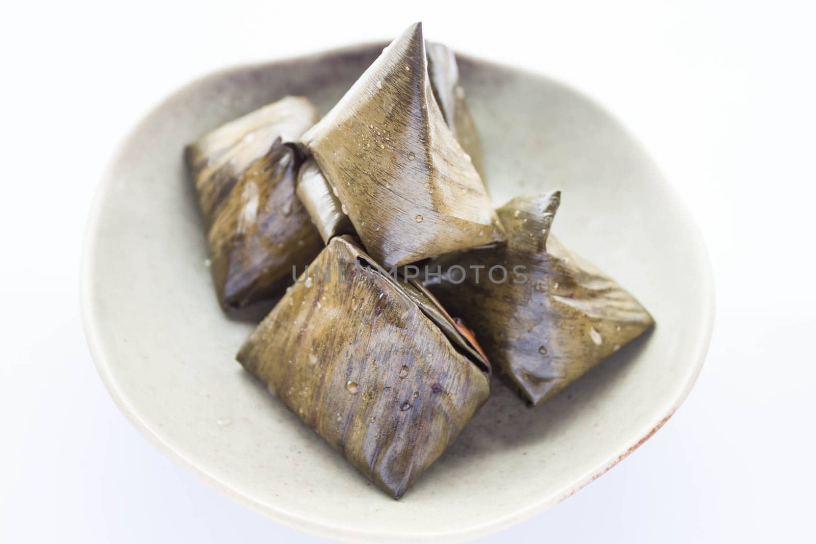 Stuffed dough pyramid dessert on plate, stock photo