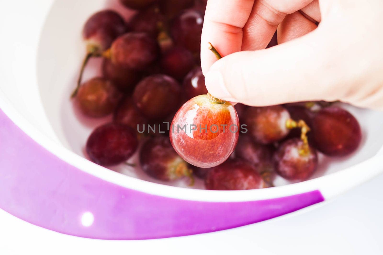 Hand on fresh grape before consume, stock photo
